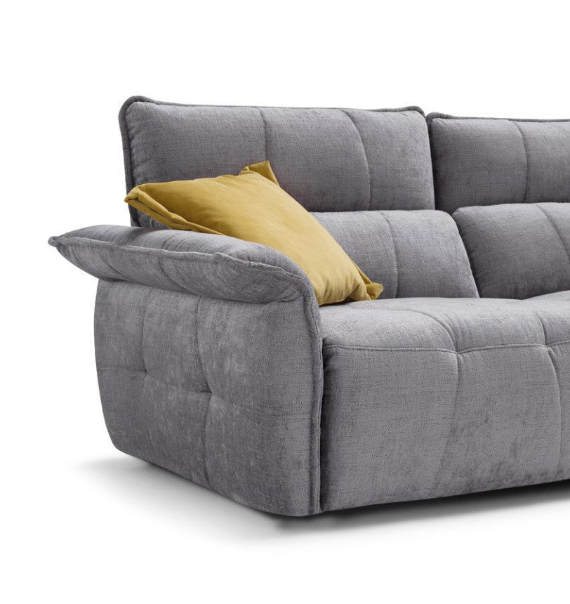 Close-up of the Borg sofa armrest and geometric quilting in grey fabric with a mustard cushion