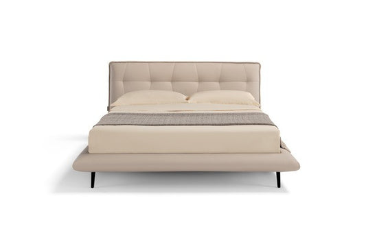 Borg Bed front view showing the tufted curved headboard, rounded bed frame and black metal legs, on white background