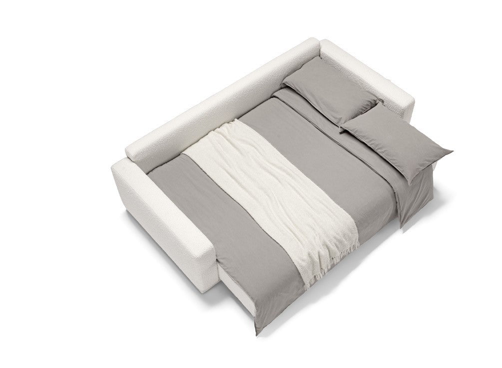 Cynar sofa bed fully opened into a bed, dressed with grey bedding and a white throw