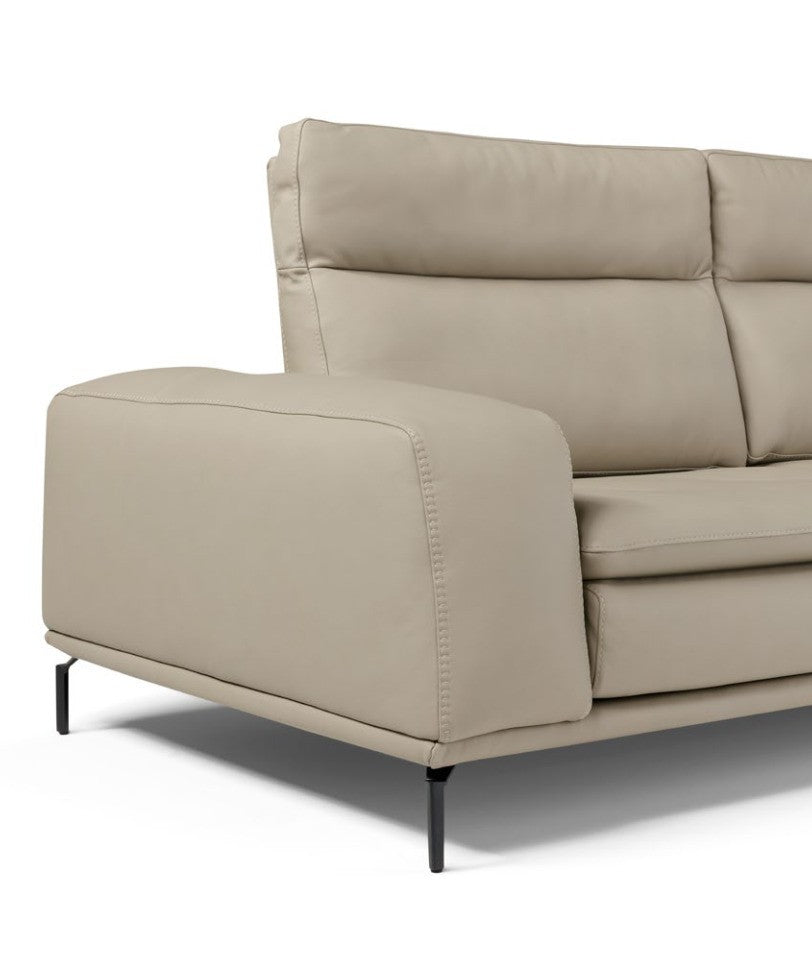 Close-up of the Denise sofa armrest, quilted backrest and black metal foot in beige leather