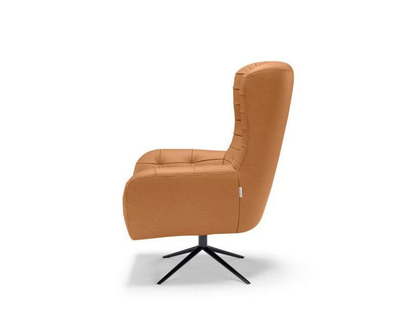 Side view of the Patrick armchair on a white background showing the tall quilted backrest and four-spoke metal base