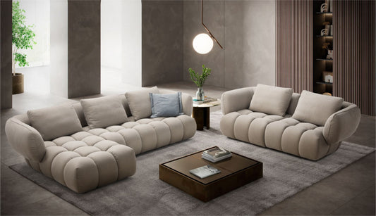 Abbracci modular sectional and sofa in a contemporary living room, upholstered in taupe fabric with blue accent pillows