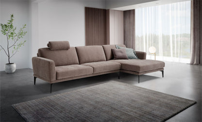 Agi sectional sofa with chaise longue and headrest in a modern living room setting