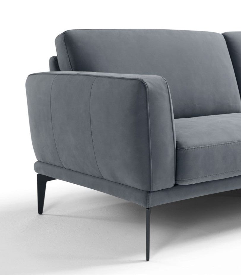 Close-up of the Agi sofa armrest showing the embossed double stitching and thin metal leg