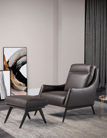Alicudi armchair with wooden base and matching ottoman in dark brown leather in a contemporary living room