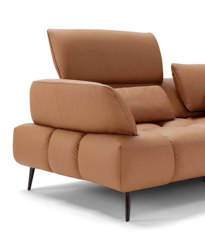 Close-up of the Ambra sofa quilted seat, adjustable backrest, armrest and slender metal foot in tan leather
