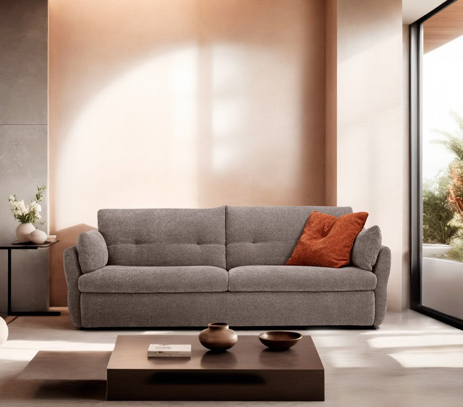 Ambrogio sofa bed in grey fabric with curved armrests and high tufted backrest in a warm contemporary living room