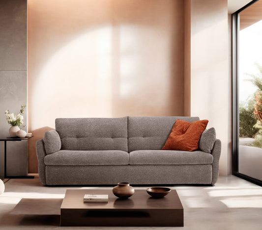 Ambrogio sofa bed in grey fabric with curved armrests and high tufted backrest in a warm contemporary living room