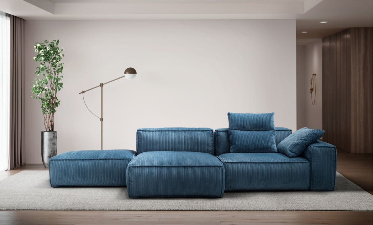 Blue corduroy-style modular sectional sofa with an open chaise end in a contemporary living room