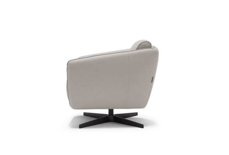 Benati armchair side view on white background showing the continuous shell and four-spoke black metal base