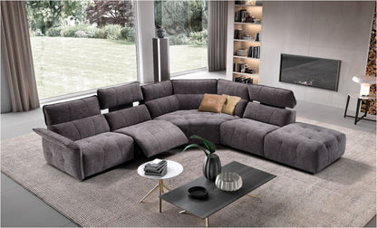 Borg modular sectional sofa in grey quilted fabric with reclined seat, corner element and terminal ottoman in a bright living room