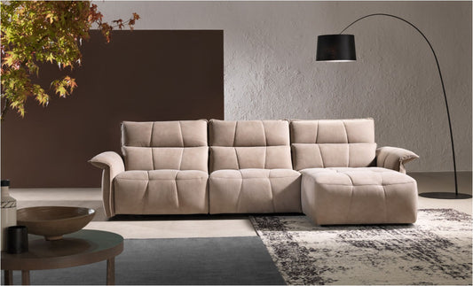 Borg sectional sofa in beige nubuck-look leather with chaise longue and geometric quilting against a textured wall