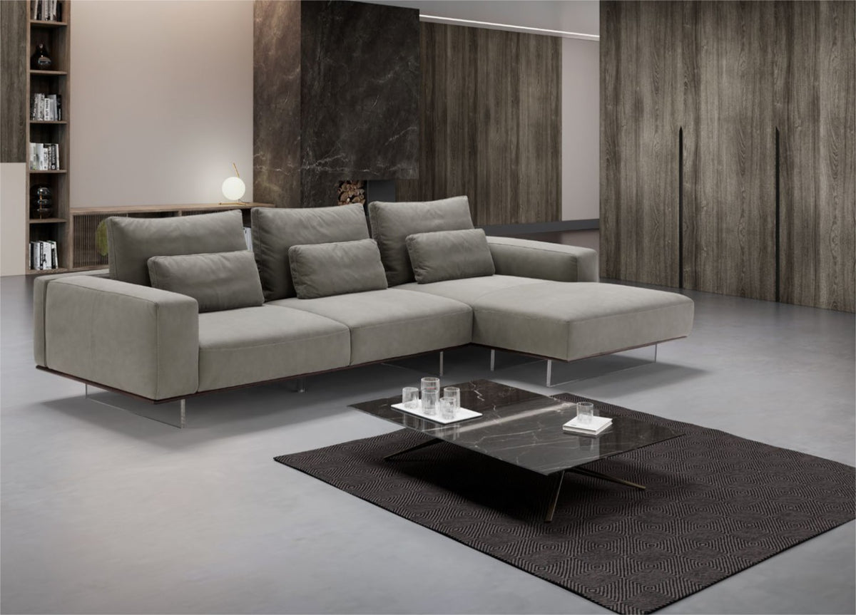 Gray leather modular sectional sofa with chaise longue in a modern living room
