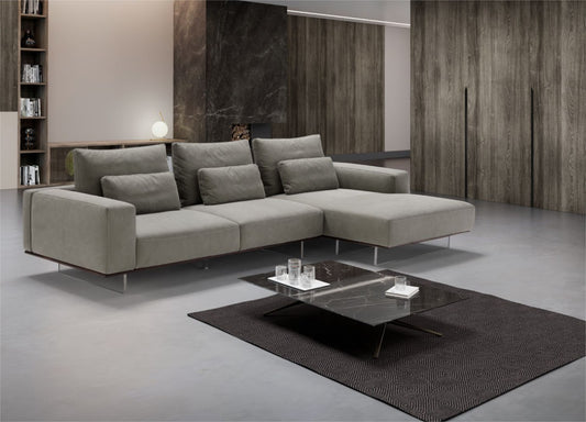 Gray leather modular sectional sofa with chaise longue in a modern living room