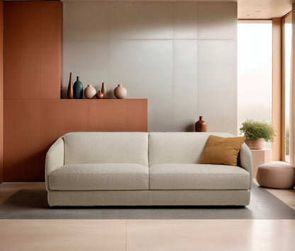 Canto three-seater sofa bed in white boucle fabric with a mustard cushion against a terracotta wall