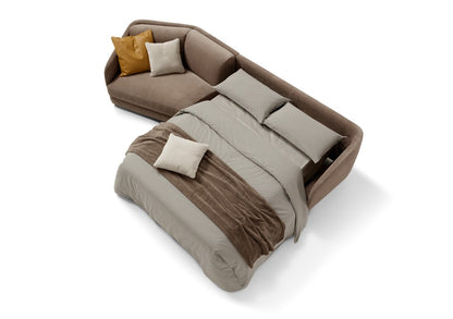 Canto sofa bed with chaise longue opened into a bed, made up with grey sheets and a brown throw, top view