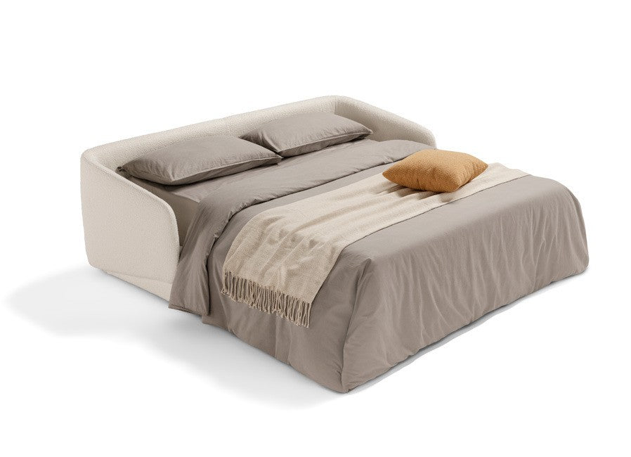 Canto three-seater sofa bed opened into a double bed with pillows, grey duvet and a beige throw