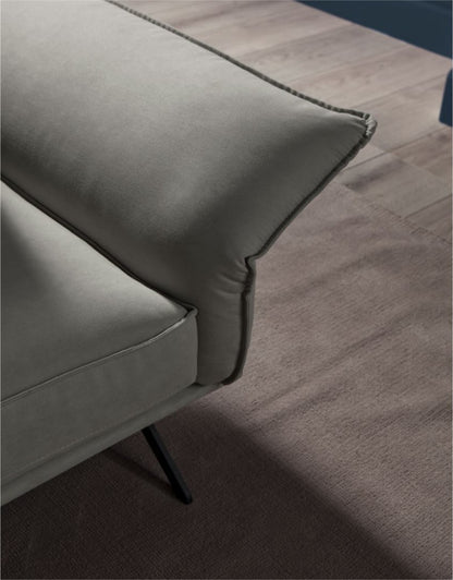 Close-up detail of the Capitolo sofa's cushion stitching and slim metal leg
