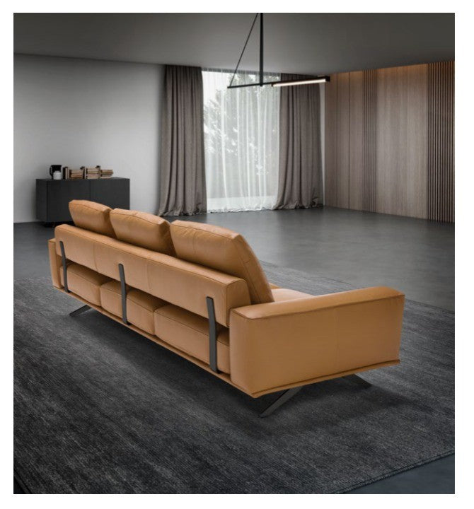Cole sectional sofa in cognac leather, rear three-quarter view showing metal backrest inserts and angled legs