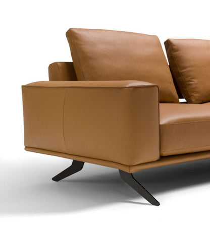 Detail of Cole sofa armrest and metal-accented backrest insert in cognac leather