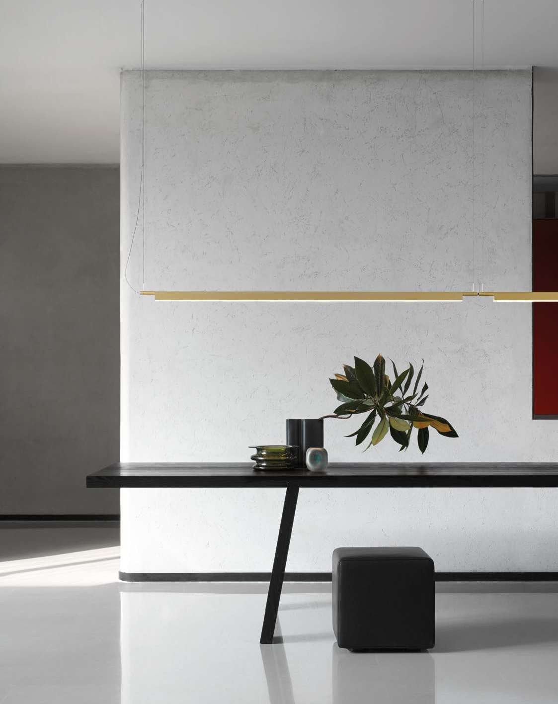 Luceplan Compendium Suspension Lamp in brass over a table