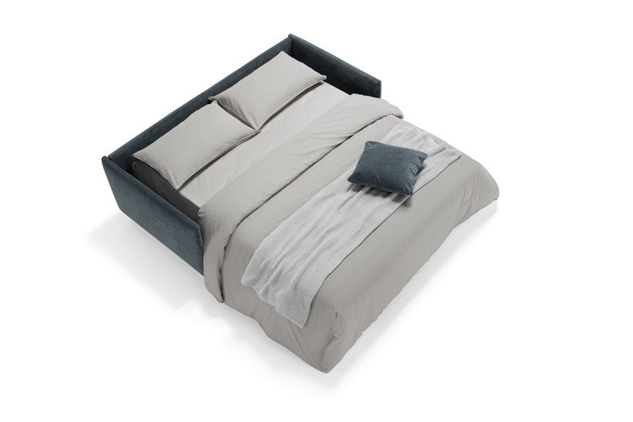 Costa sofa bed in blue fabric opened into a bed with mattress, pillows and duvet