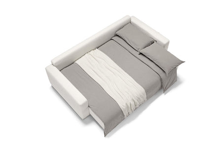 Cynar sofa bed fully opened into a bed, dressed with grey bedding and a white throw