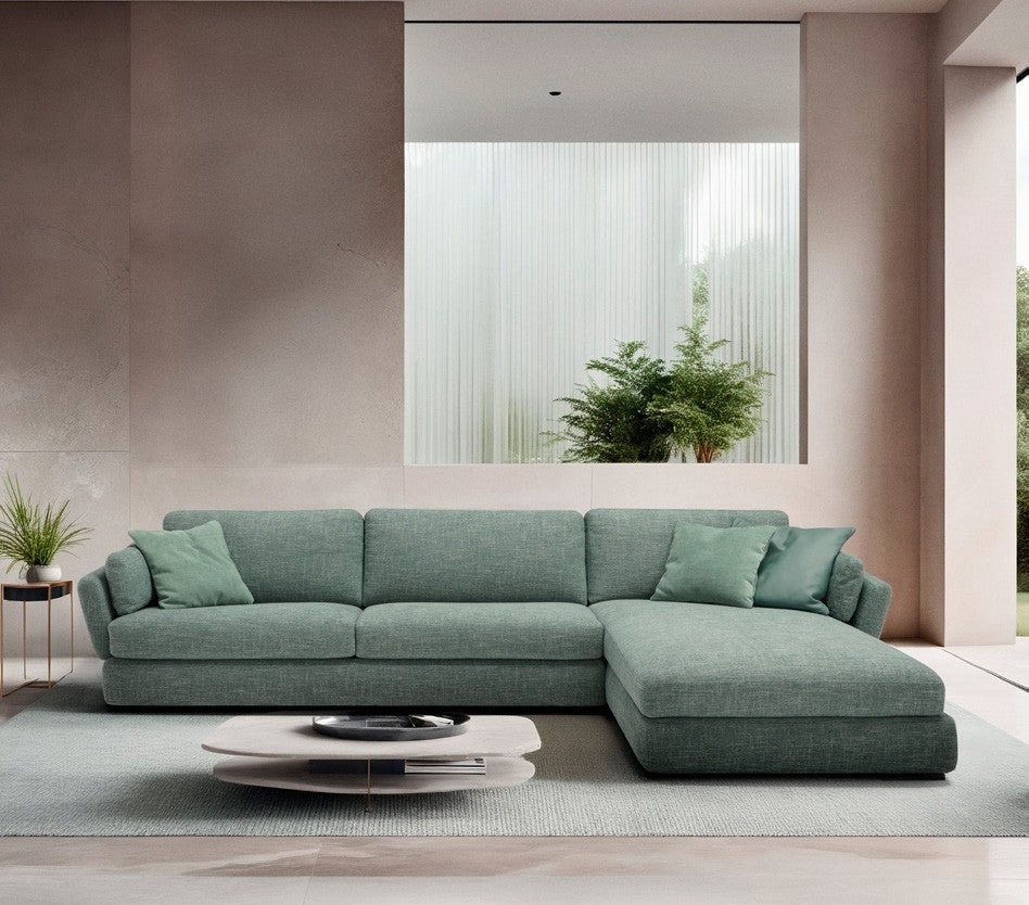 Dambo sectional sofa bed in sage green fabric with chaise longue in a bright contemporary living room