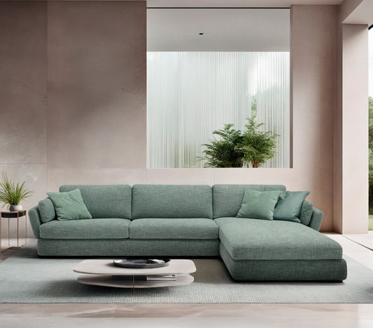 Dambo sectional sofa bed in sage green fabric with chaise longue in a bright contemporary living room