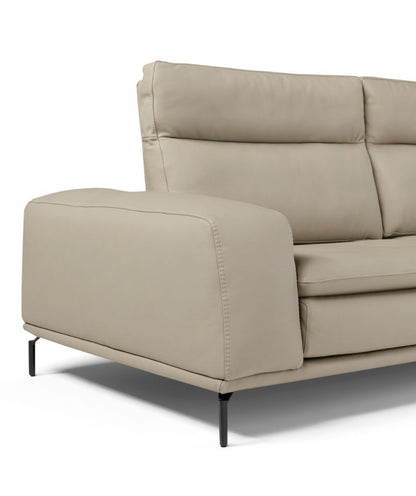 Close-up of the Denise sofa armrest, quilted backrest and black metal foot in beige leather