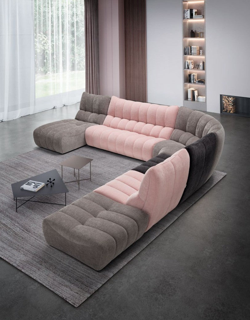 Deseo modular sofa in a U-shaped composition with two chaise longues in pink and grey quilted fabric, seen from above in a living room