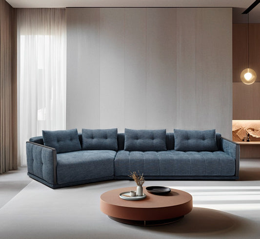 Desiderio modular sofa bed in blue fabric with angled terminal element in a contemporary living room with a round terracotta coffee table