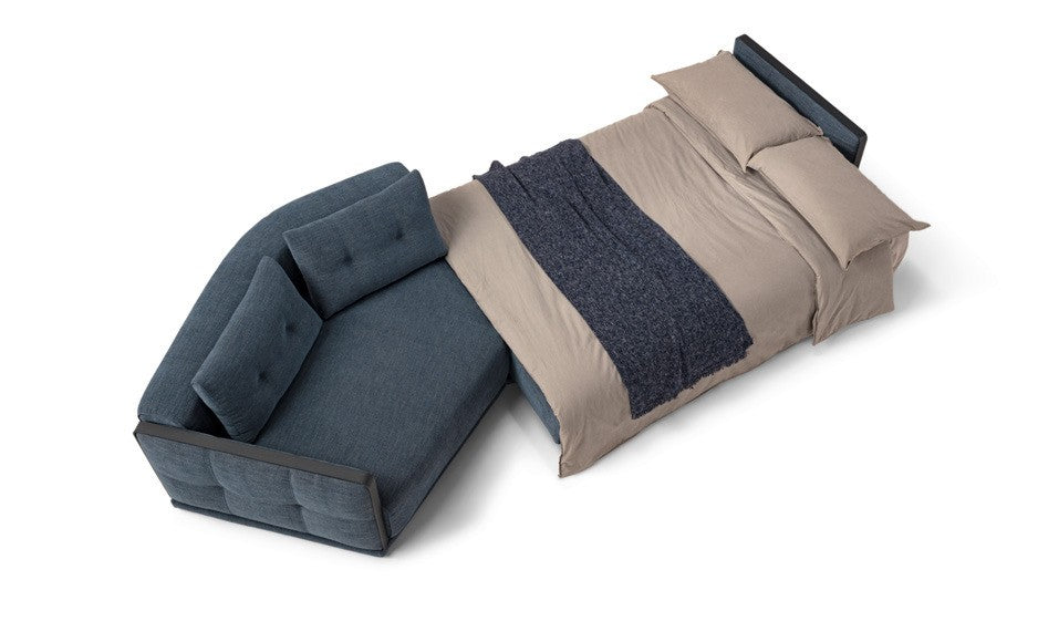 Desiderio sofa bed opened into a bed with bedding and pillows, viewed from above