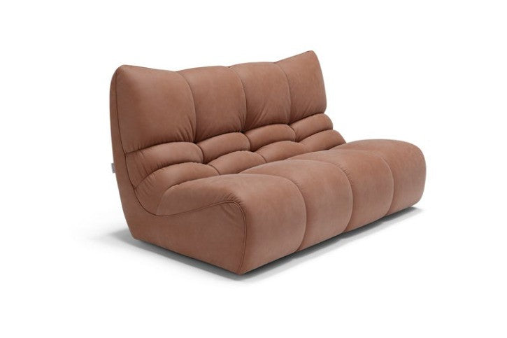 Formosa two-seater sofa in tan leather, angled view showing the curved quilted backrest and armless design