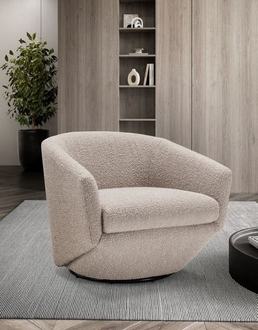 Fracco armchair in textured beige fabric, angled view in a living room with wood panelling, shelving and a plant