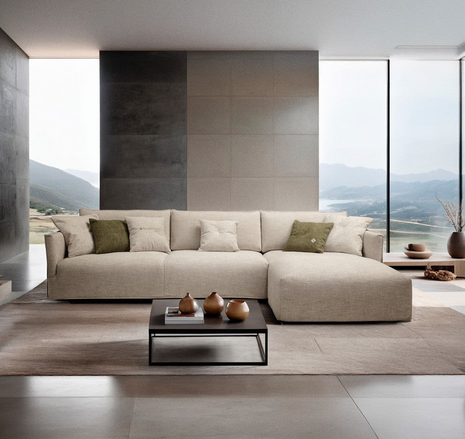 Fraser sofa bed with chaise longue in light beige fabric in a contemporary living room with mountain views