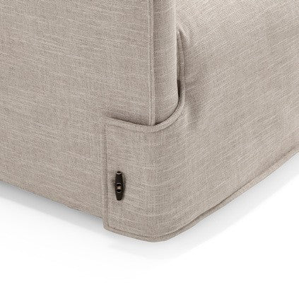 Detail of the Fraser tailored fabric cover with toggle fastening on the armrest