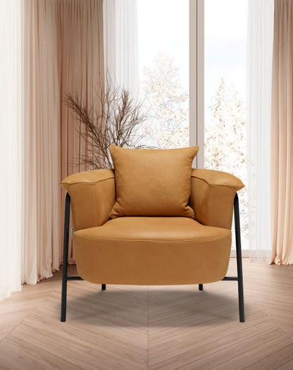 Gin armchair in tan leather, front view beside a window with a loose back cushion on the round backrest