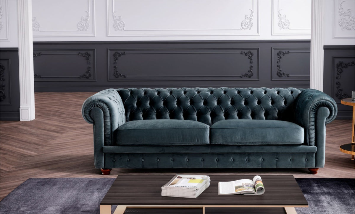Teal velvet chesterfield sofa with rolled tufted arms in an elegant living room