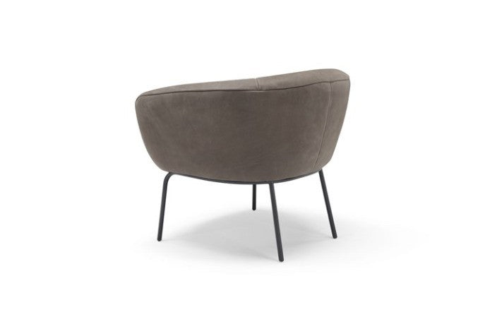 Rear view of the Jill armchair in taupe leather showing the wraparound shell and metal legs