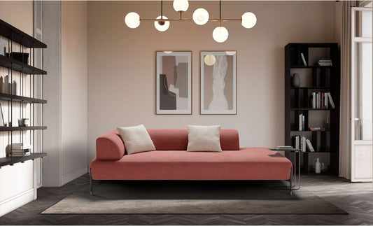Jordan lounge sofa in coral boucle fabric with curved side backrest and slim black metal legs in a contemporary living room