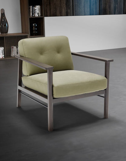 Lauro armchair in sage green leather with a wenge-toned beech wood and metal frame, three-quarter view in a contemporary living room