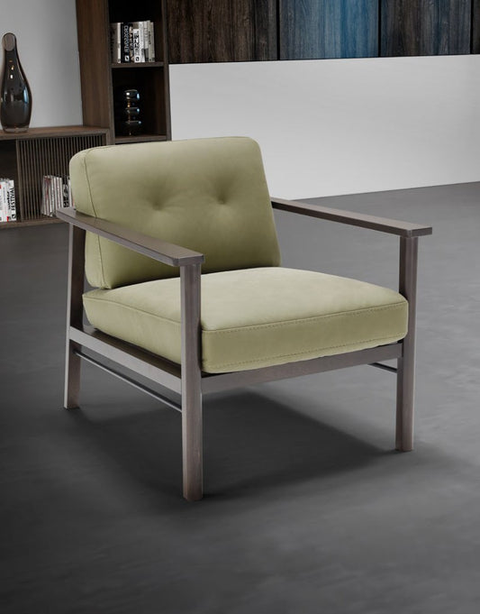 Lauro armchair in sage green leather with a wenge-toned beech wood and metal frame, three-quarter view in a contemporary living room