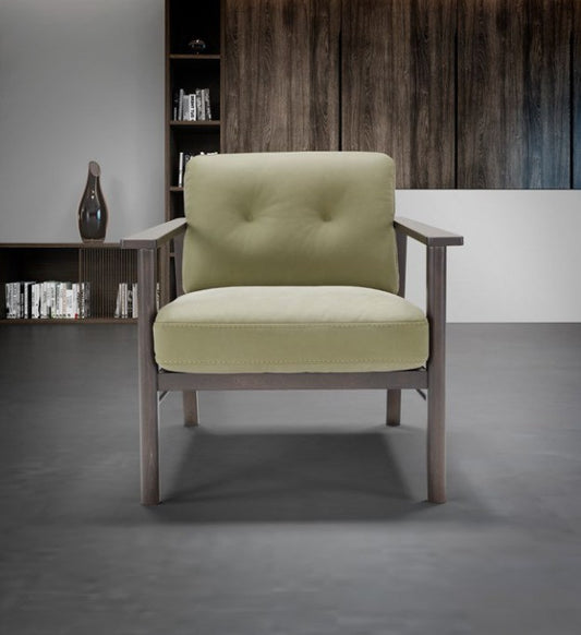 Front view of the Lauro armchair with button-stitched backrest cushion and exposed wood frame in a modern interior