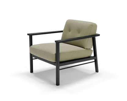 Lauro armchair with black frame and light green leather cushions, three-quarter view on white background