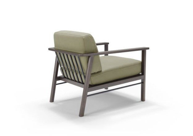 Rear three-quarter view of the Lauro armchair showing the metal slatted backrest and beech wood frame