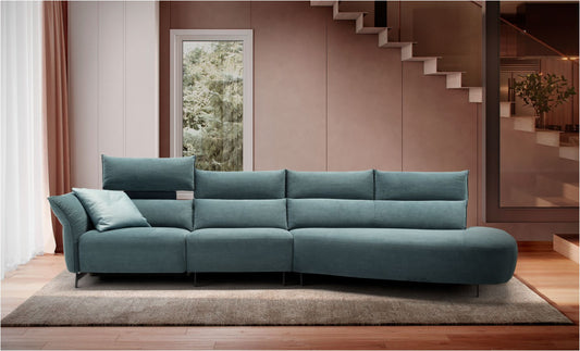 Levi Light sectional sofa in teal fabric with raised electric headrest and curved terminal element in a living room