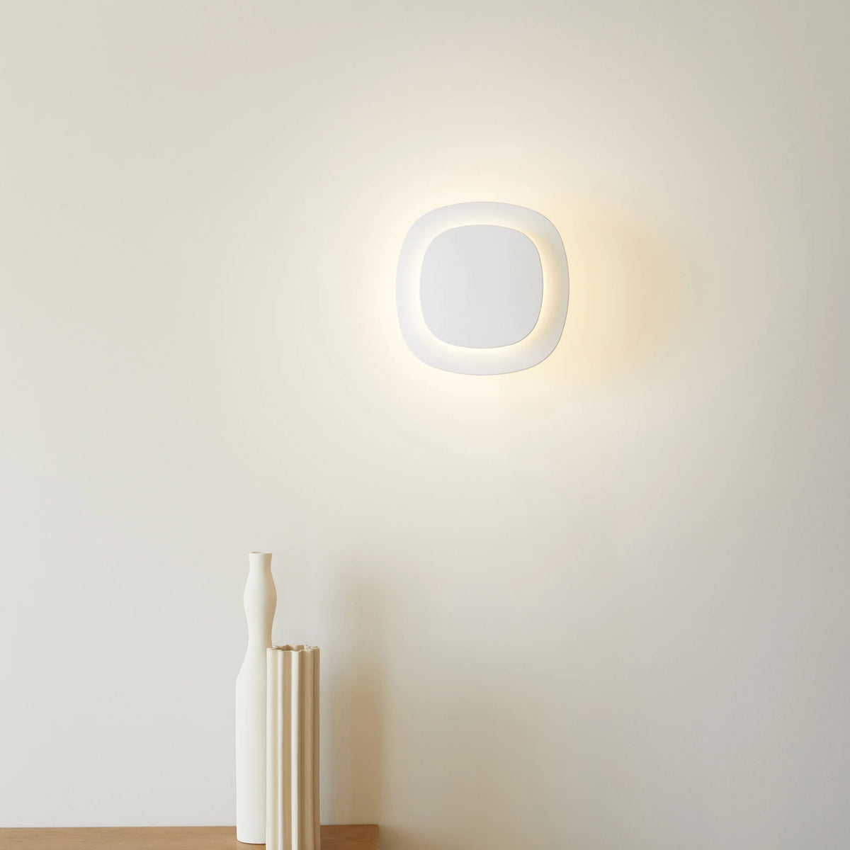 Luceplan Luthien Wall Lamp illuminated on a wall