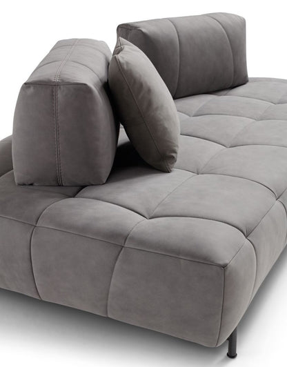 Close-up of the Marvel sofa's quilted grey leather seat with freestanding backrest cushions and slim metal foot
