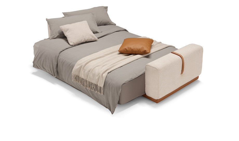 Memo sofa bed opened into a bed and dressed with grey bedding and a cream throw